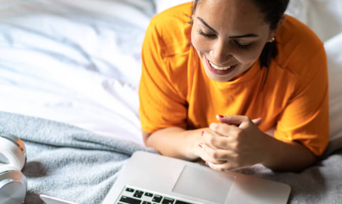 Woman smiling looking at Laptop